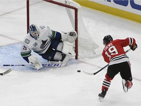 Chicago Blackhawks centre Jonathan Toews shoots the puck against Vancouver Canucks goaltender Jacob Markstrom during the second period at United Center.