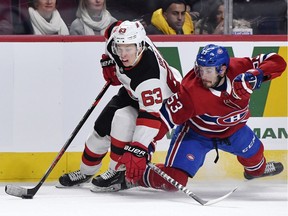 New Jersey Devils forward Jesper Bratt plays the puck as Montreal Canadiens defenceman Victor Mete defends during the second period at the Bell Centre on Nov. 16, 2019.