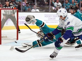Vancouver Canucks centre Brandon Sutter shoots the puck past San Jose Sharks goaltender Aaron Dell to score a goal during the first period at SAP Center at San Jose.