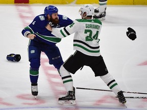 Canucks defenceman Jordie Benn fights with Dallas Stars forward Roope Hintz during the first period at Rogers Arena.