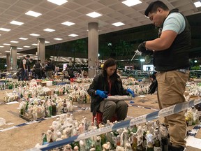 Kong police officers inspect and catalogue thousands of Molotov cocktails collected on the campus of the Hong Kong Polytechnic University on November 28, 2019 in Hong Kong. (Billy H.C. Kwok/Getty Images)