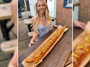 Kate Ovens with a three-foot-long hot dog. (Instagram)
