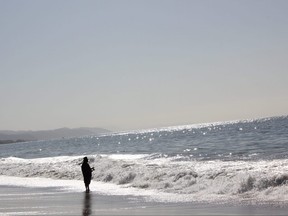 A fisherman casts his line into the Pacific Ocean at Summerland Beach in Santa Barbara. (IAN SHANTZ/THE TORONTO SUN)