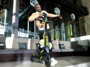 Olympic gold medallist Usain Bolt poses for a photograph as he shows off an electric scooter at a launch event in Tokyo, Japan November 15, 2019.
