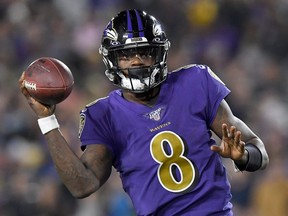 Ravens quarterback Lamar Jackson looks to deliver a pass over the defence of the Rams during NFL action at Los Angeles Memorial Coliseum in Los Angeles, on Monday, Nov. 25, 2019.