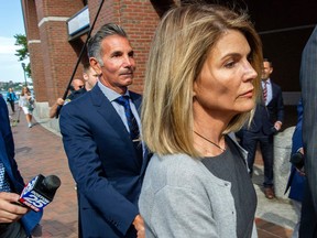 In this file photo taken on August 27, 2019, actress Lori Loughlin and husband Mossimo Giannulli exit the Boston Federal Court house after a pre-trial hearing with Magistrate Judge Kelley at the John Joseph Moakley United States Courthouse in Boston. (JOSEPH PREZIOSO/AFP via Getty Images)