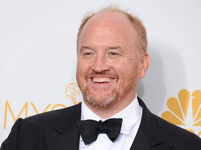 Louis C.K. poses with his award in the press room at the 66th Annual Primetime Emmy Awards at the Nokia Theatre L.A. Live on Monday, Aug. 25, 2014, in Los Angeles. ( Jordan Strauss/Invision/AP)