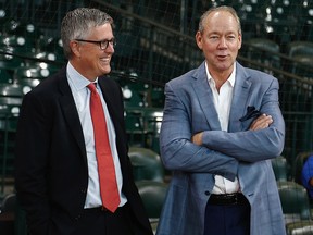 Houston Astros owner Jim Crane, right, and general manager Jeff Luhnow chat during batting practice at Minute Maid Park on June 30, 2017 in Houston. (Bob Levey/Getty Images)