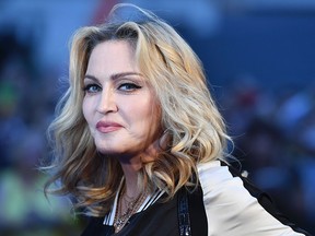 Madonna poses arriving on the carpet to attend a special screening of the film "The Beatles Eight Days A Week: The Touring Years" in London on Sept. 15, 2016.