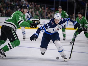 Stars’ Esa Lindell (left) defends against Jets’ Mark Scheifele on Thursday night in Dallas. (USA TODAY SPORTS PHOTO)