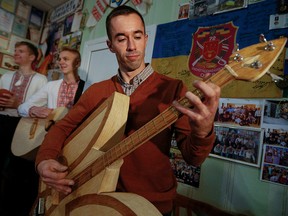 Ukrainian craftsman Bogdan Senchukov plays the unique musical instrument "Herbas" made of safety matches during a rehearsal in the town of Zhashkiv, Ukraine, Nov. 7, 2019.
