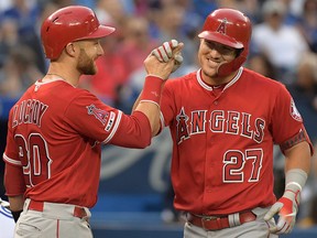 Los Angeles Angels centre fielder Mike Trout (27) is greeted by catcher Jonathan Lucroy after hitting a grand slam against the Toronto Blue Jays at Rogers Centre. (Dan Hamilton-USA TODAY Sports)