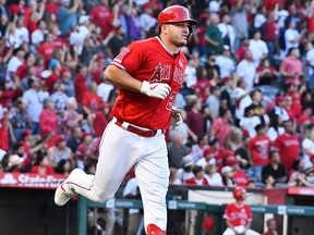 In this July 13, 2019, file photo, Los Angeles Angels centre fielder Mike Trout rounds the bases after hitting a two-run home run  in the 3rd inning against the Seattle Mariners at Angel Stadium of Anaheim in Anaheim, Calif.