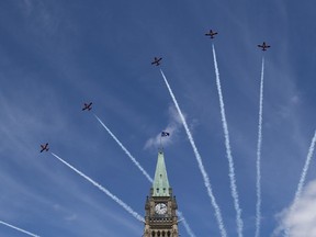 Royal Canadian Air Force Snowbirds fly past the Peace Tower during the Canada Day noon show on Parliament Hill in Ottawa on Monday, July 1, 2019.