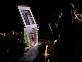 A girl looks at the coffins with the remains of Rhonita Miller and four of her children, who were among the nine victims killed on Nov. 4, 2019, in an attack authorities have blamed on a drug cartel, on their way to their burial at the cemetery of La Mora Ranch in the municipality of Bavispe, Sonora State, Mexico, on Nov. 7, 2019.