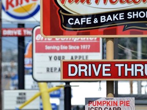 Fast food restaurant signs are shown.