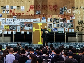 Students attend a ceremony to pay tribute to Chow Tsz-lok, 22, a university student who fell during protests at the weekend and died early on Friday morning, at the Hong Kong University of Science and Technology (HKUST) on Nov. 8, 2019 in Hong Kong, China.