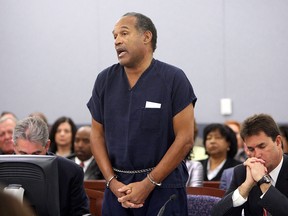 In this file photo taken on December 4, 2008, O.J. Simpson speaks in court prior to his sentencing as his attorneys Gabriel Grasso (left) and Yale Galanter listen at the Clark County Regional Justice Center in Las Vegas. (ISAAC BREKKEN/AFP/Getty Images)