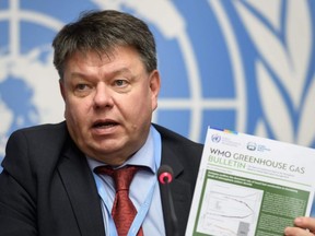 World Meteorological Organization (WMO) secretary-general Petteri Taalas shows the latest WMO Greenhouse Gas Bulletin during a press conference for the publishing of the latest atmospheric concentrations of CO2 in Geneva on Monday, Nov. 25, 2019.