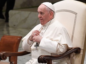 Pope Francis adjusts his necklace during an audience with students and teachers of Roma's LUMSA Catholic University, on November 14, 2019 at Paul-VI hall in the Vatican. (ANDREAS SOLARO/AFP via Getty Images)