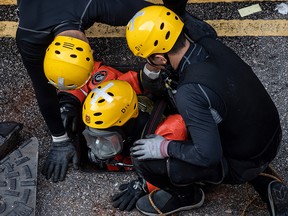 A rescue diver from the fire services department enters the sewage system to search for protesters, who escaped from Hong Kong Poytechnic University after being barricaded inside for days on November 20, 2019. (PHILIP FONG/AFP via Getty Images)