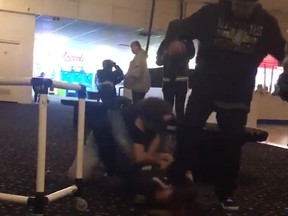 A man is seen stomping on a woman's head during a fight at a Colorado roller rink on Nov. 2, 2019.