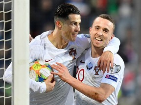 Portugal's Cristiano Ronaldo (left) celebrates after scoring a goal during Euro 2020 qualifying against Luxembourg at the Josy Barthel Stadium in Luxembourg on November 17, 2019. (JOHN THYS/AFP via Getty Images)