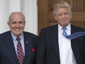 In this file photo taken on November 20, 2016, Donald Trump meets with former New York City Mayor Rudy Giuliani at the clubhouse of the Trump National Golf Club in Bedminster, New Jersey. (DON EMMERT/AFP/Getty Images)