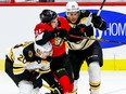 Ottawa Senators Logan Brown tries to split the checks of Boston Bruins Joakim Nordstrom (#20) and Brandon Carlo during NHL action at the Canadian Tire Centre on Wednesday November 27, 2019. Errol McGihon/Postmedia