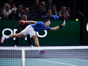 Canada's Denis Shapovalov returns the ball to Serbia's Novak Djokovic during their men's singles final tennis match at the ATP World Tour Masters 1000 - Rolex Paris Masters - indoor tennis tournament at The AccorHotels Arena in Paris on Nov. 3, 2019.