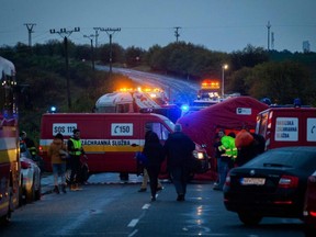 Emergency services are shown working at the scene of a collision between a public bus and a truck near the village of Malanta, western Slovakia, on Wednesday, Nov. 13, 2019.