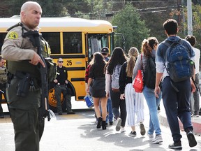 Students are evacuated from Saugus High School onto a school bus after a shooting at the school left two students dead and three wounded on Nov.14, 2019 in Santa Clarita, Calif.
