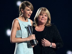 In this April 19, 2015, file photo, honouree Taylor Swift (L) accepts the Milestone Award from her mom Andrea Swift onstage during the 50th Academy Of Country Music Awards at AT&T Stadium in Arlington, Texas.