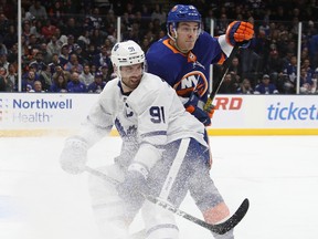 Mathew Barzal of the New York Islanders holds up John Tavares of the Toronto Maple Leafs during the second period at NYCB Live's Nassau Coliseum on Nov. 13, 2019 in Uniondale, N.Y.