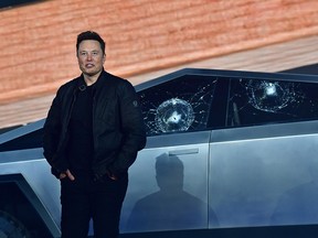 Tesla co-founder and CEO Elon Musk stands in front of the shattered windows of the newly unveiled all-electric battery-powered Tesla Cybertruck at Tesla Design Center in Hawthorne, California on November 21, 2019. (FREDERIC J. BROWN/AFP via Getty Images)