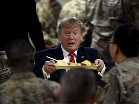 President Donald Trump serves Thanksgiving dinner to U.S. troops at Bagram Air Field during a surprise visit on November 28, 2019 in Afghanistan. (OLIVIER DOULIERY/AFP via Getty Images)