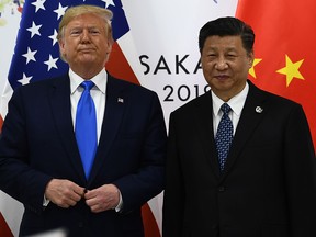 Chinese President Xi Jinping (R) and US President Donald Trump attend their bilateral meeting on the sidelines of the G20 Summit in Osaka on June 29, 2019.