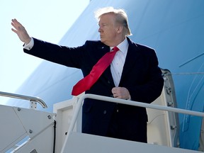 U.S. President Donald Trump boards Air Force One as he departs at John F. Kennedy international airport after attending an MMA match the night before in New York City on Nov. 3, 2019.