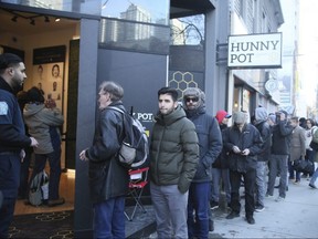 People line up to visit the Hunny Pot marijuana shop as it opens on Queen St. W. in Toronto on April 1, 2019 in Toronto. Veronica Henri/Toronto Sun