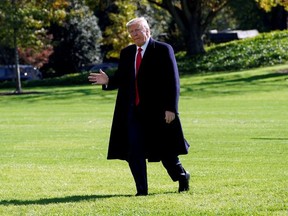 U.S. President Donald Trump waves to the media as he walks on the South Lawn of the White House in Washington upon his return from New York, U.S., November 3, 2019.