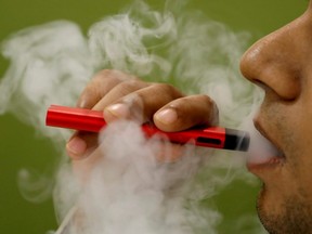 A man in India uses a vape device in this illustration picture, on Sept. 19, 2019.