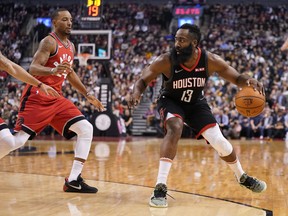 Houston Rockets guard James Harden dribbles the ball against Toronto Raptors guard Norman Powell during Thursday's game. (USA TODAY SPORTS)