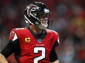 Matt Ryan of the Atlanta Falcons reacts after a touchdown is scored in the second half on an NFL game against the Carolina Panthers at Mercedes-Benz Stadium on December 8, 2019 in Atlanta, Georgia.