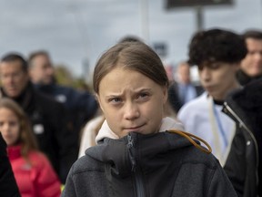 Swedish environment activist Greta Thunberg (C) arrives at the COP25 Climate Conference on December 06, 2019 in Madrid, Spain. Greta arrived in Madrid after a ten-hour journey by train from Lisbon, Portugal to attend the Global March for Climate rally that will be held in the Spanish capital this evening.