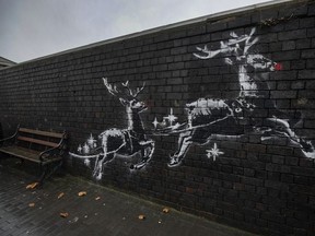 Red noses have appeared on Banksy's Birmingham homeless reindeer mural, which has also been fenced off to protect the artwork,  on a railway bridge wall in Vyse Street on December 10, 2019 in Birmingham, England.