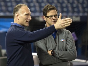 Jays president Mark Shapiro (left) and GM Ross Atkins talk before a game last season. (CRAIG ROBERTSON/Toronto Sun)