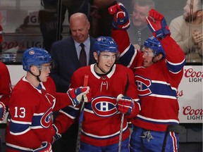 Canadiens coach Claude Julien is all smiles and Max Domi (13), Nick Suzuki, middle, and Nick Cousins celebrate Shea Weber's empty-net goal, which sealed Tuesday night's victory at the Bell Centre.