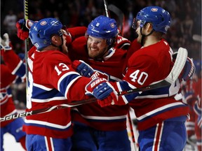 Canadiens defenceman Ben Chiarot (centre) celebrates with teammates Max Domi (left) and Joel Armia after scoring in overtime to give his team a 3-2 win over the Ottawa Senators in NHL game at the Bell Centre in Montreal on Dec. 11, 2019.