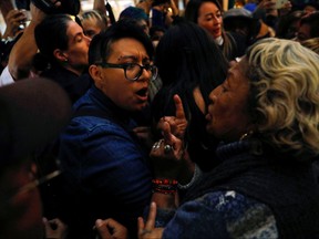 A group of people, who are part of a farm union, block the entrance of the Fine Arts Palace as they fight with LGBT members about a painting showing Mexican revolutionary hero Emiliano Zapata nude while wearing high heels and riding a horse, in Mexico City, Mexico December 10, 2019. REUTERS/Carlos Jasso