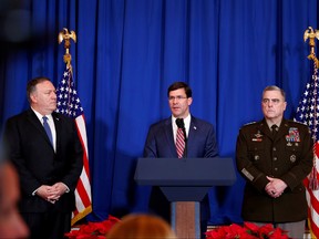 U.S. Defense Secretary Mark Esper, centre, speaks about airstrikes by the U.S. military in Iraq and Syria, at the Mar-a-Lago resort in Palm Beach, Fla., Dec. 29, 2019. With him are U.S. Army General Mark Milley,  right, and U.S. Secretary of State Mike Pompeo. (REUTERS/Tom Brenner)